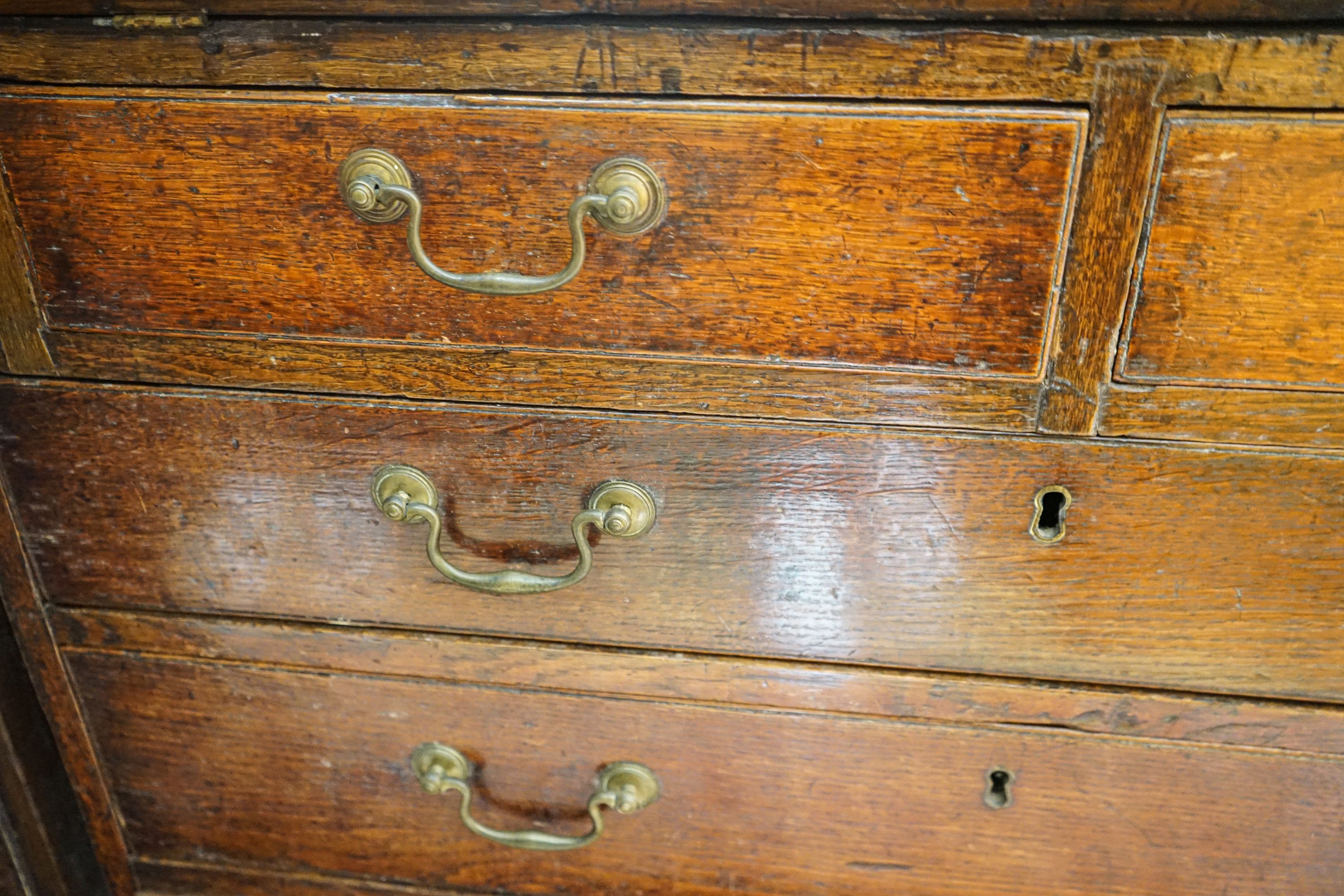 A George III oak bureau, with fitted interior, two short and three long drawers, width 92cm, depth 50cm, height 100cm
